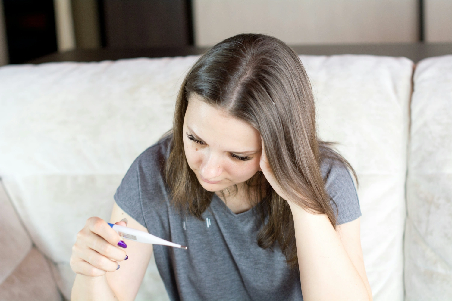 woman looking at thermometer