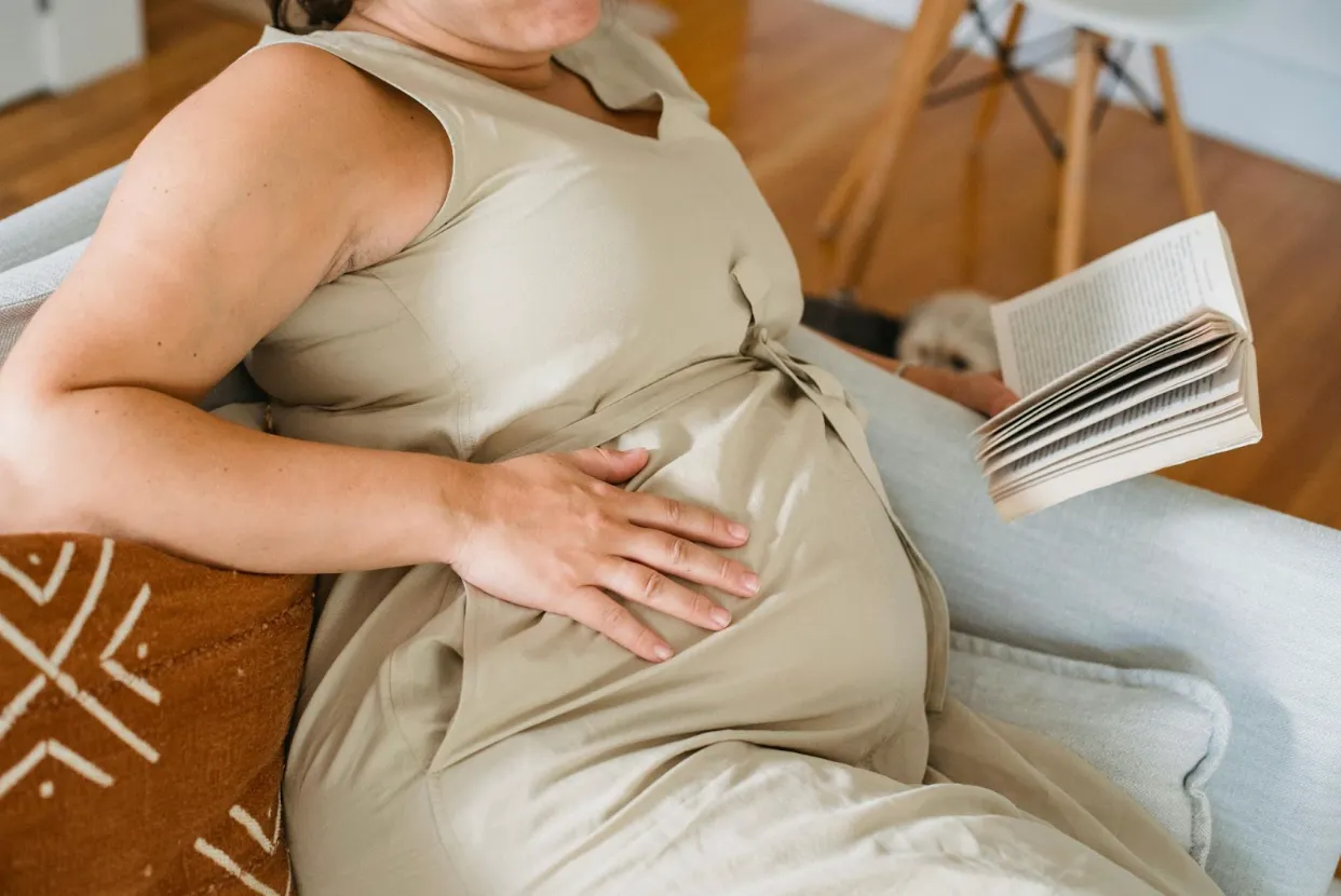 pregnant woman sitting and reading